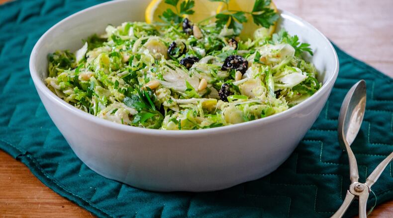 Crispy raw, shaved Brussels sprouts, tossed in whole lemon dressing with dried cherries and herbs, make a delicious hearty slaw. (Courtesy of Virginia Willis)