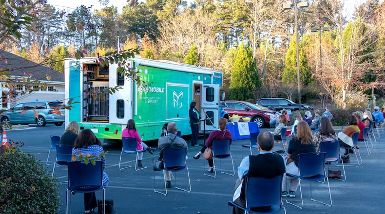 Forsyth County library and county government officials, staff and residents participate in a socially distanced ribbon cutting Nov. 16 to welcome "Loanie," the library's new $400,000 Bookmobile.