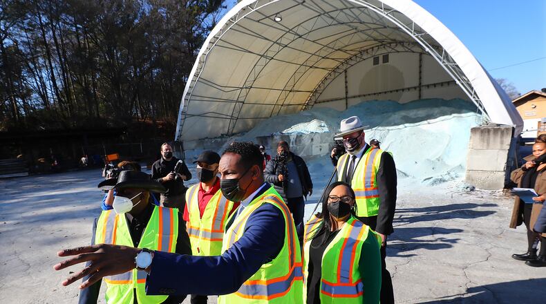 012722 Atlanta:  Atlanta Mayor Andre Dickens (center from left),  Congresswoman Nikema Williams and Atlanta Department of Transportation Commissioner Josh Rowan take in a salt barn during a tour of the ATLDOT North Avenue facility following a press briefing on how the Infrastructure Investment and Jobs Act will invest in Atlanta’s infrastructure on Thursday, Jan. 27, 2022, in Atlanta.   “Curtis Compton / Curtis.Compton@ajc.com”`