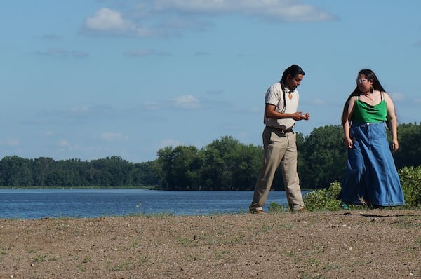 Derek Walking Eagle walks by the Mississippi River before attending a ceremony honoring high school graduates by presenting them with a bald eagle feather at the Prairie Island Indian Community in Minnesota on Wednesday, July 9, 2025. (AP Photo/Giovanna Dell'Orto)