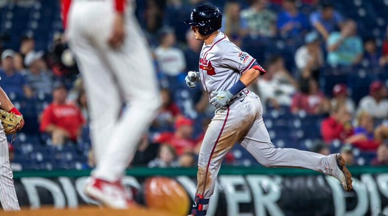 Atlanta Braves' Austin Riley runs past Philadelphia Phillies relief pitcher Connor Brogdon after hitting a home run during the eighth inning of a baseball game Tuesday, June 8, 2021, in Philadelphia. (AP Photo/Laurence Kesterson)