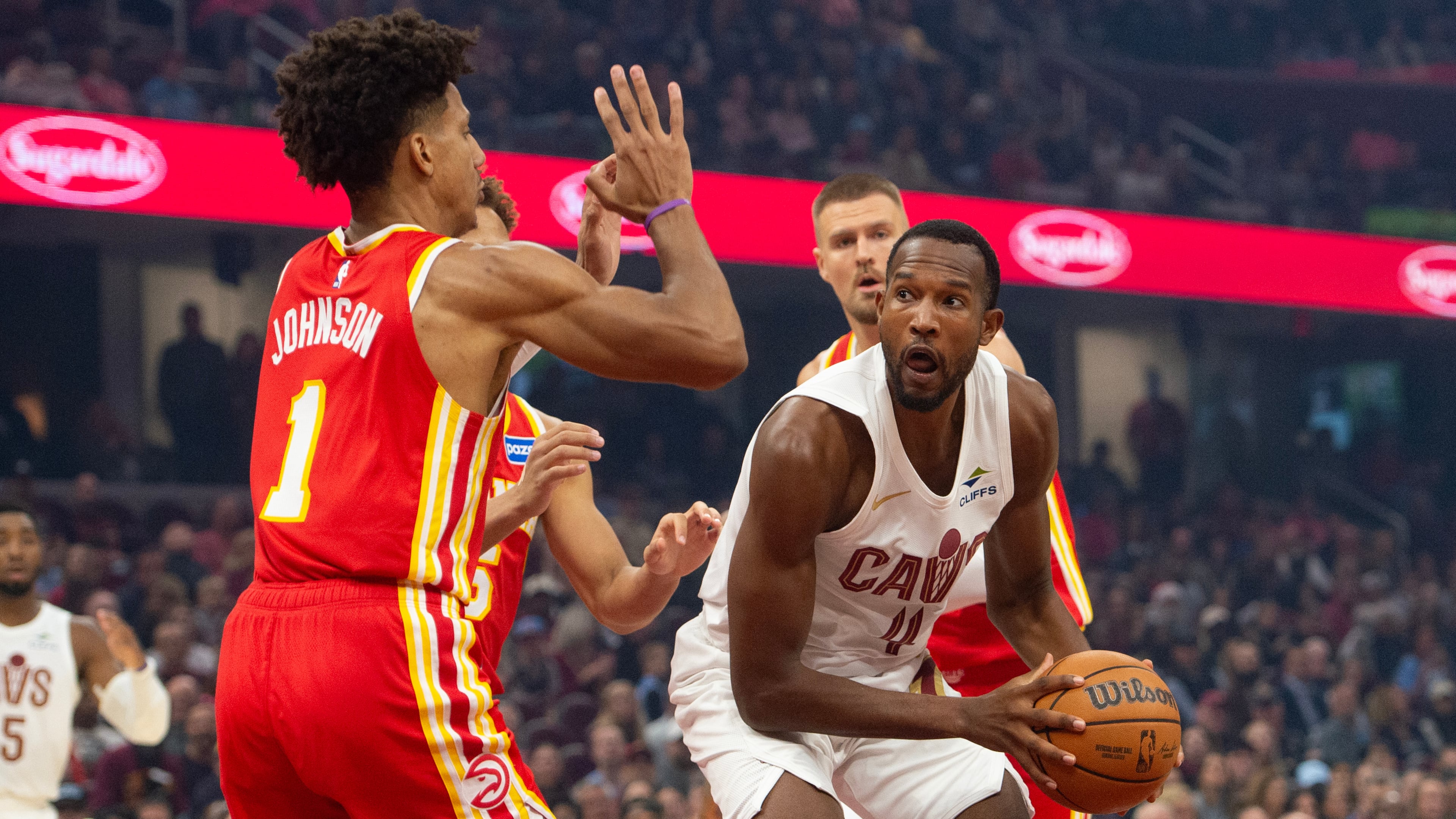 Atlanta Hawks' Jalen Johnson (1) defends as Cleveland Cavaliers' Evan Mobley (4) prepares to shoot during the first half of an NBA basketball game in Cleveland, Sunday, Nov. 2, 2025. (AP Photo/Phil Long)
