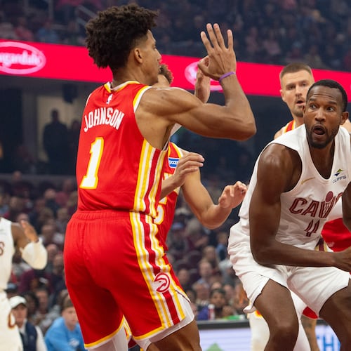 Atlanta Hawks' Jalen Johnson (1) defends as Cleveland Cavaliers' Evan Mobley (4) prepares to shoot during the first half of an NBA basketball game in Cleveland, Sunday, Nov. 2, 2025. (AP Photo/Phil Long)