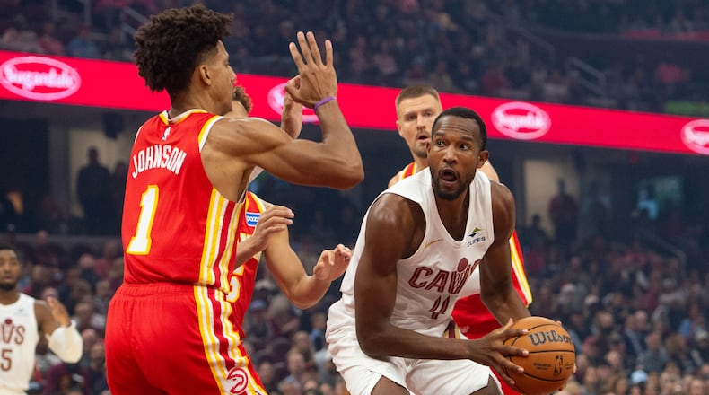 Atlanta Hawks' Jalen Johnson (1) defends as Cleveland Cavaliers' Evan Mobley (4) prepares to shoot during the first half of an NBA basketball game in Cleveland, Sunday, Nov. 2, 2025. (AP Photo/Phil Long)