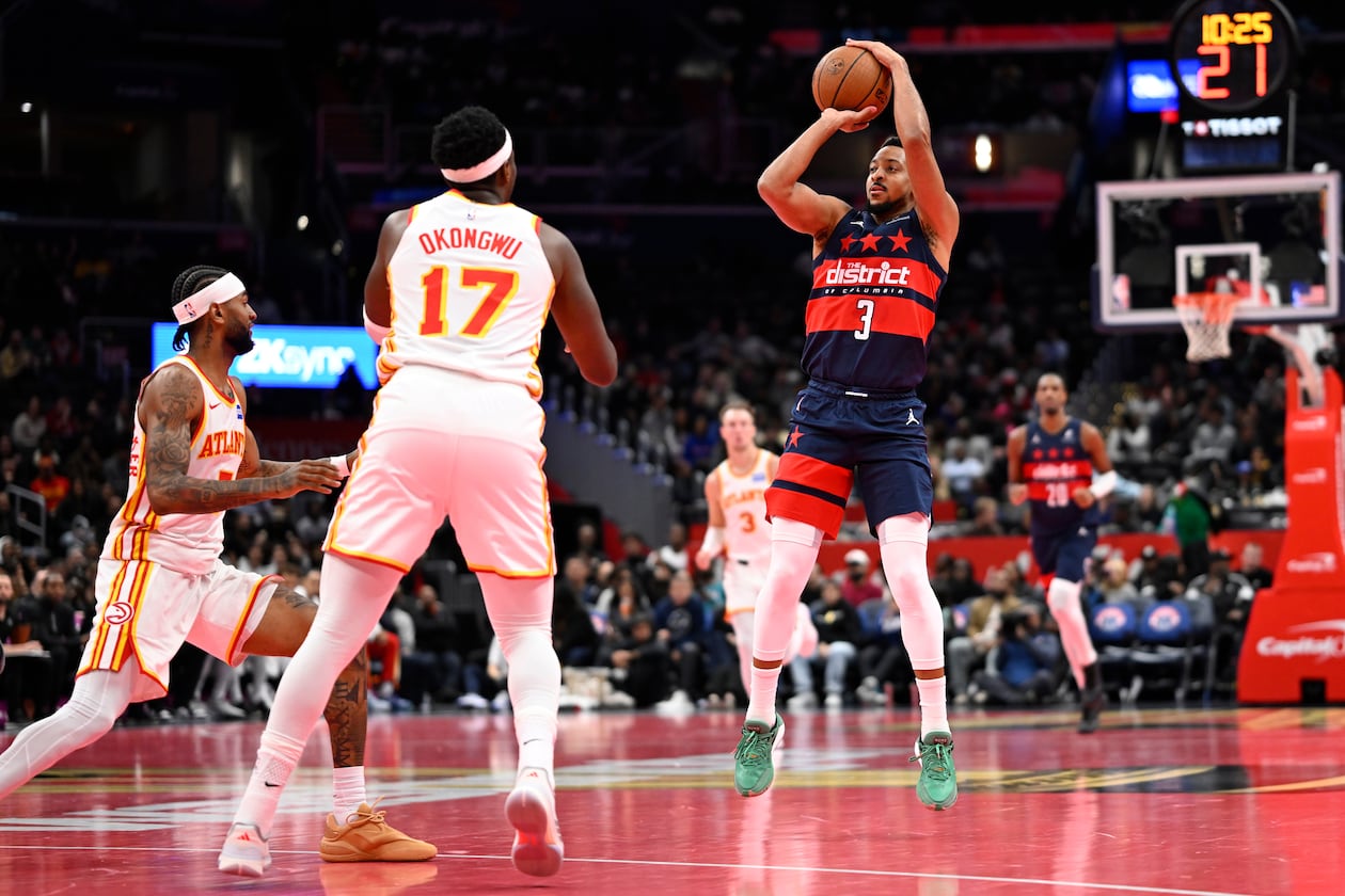Washington Wizards guard CJ McCollum (3) launches a three point shot in front of Atlanta Hawks forward Onyeka Okongwu (17) during the first half of a Emirates NBA Cup basketball game Tuesday, Nov. 25, 2025, in Washington. (John McDonnell/AP)