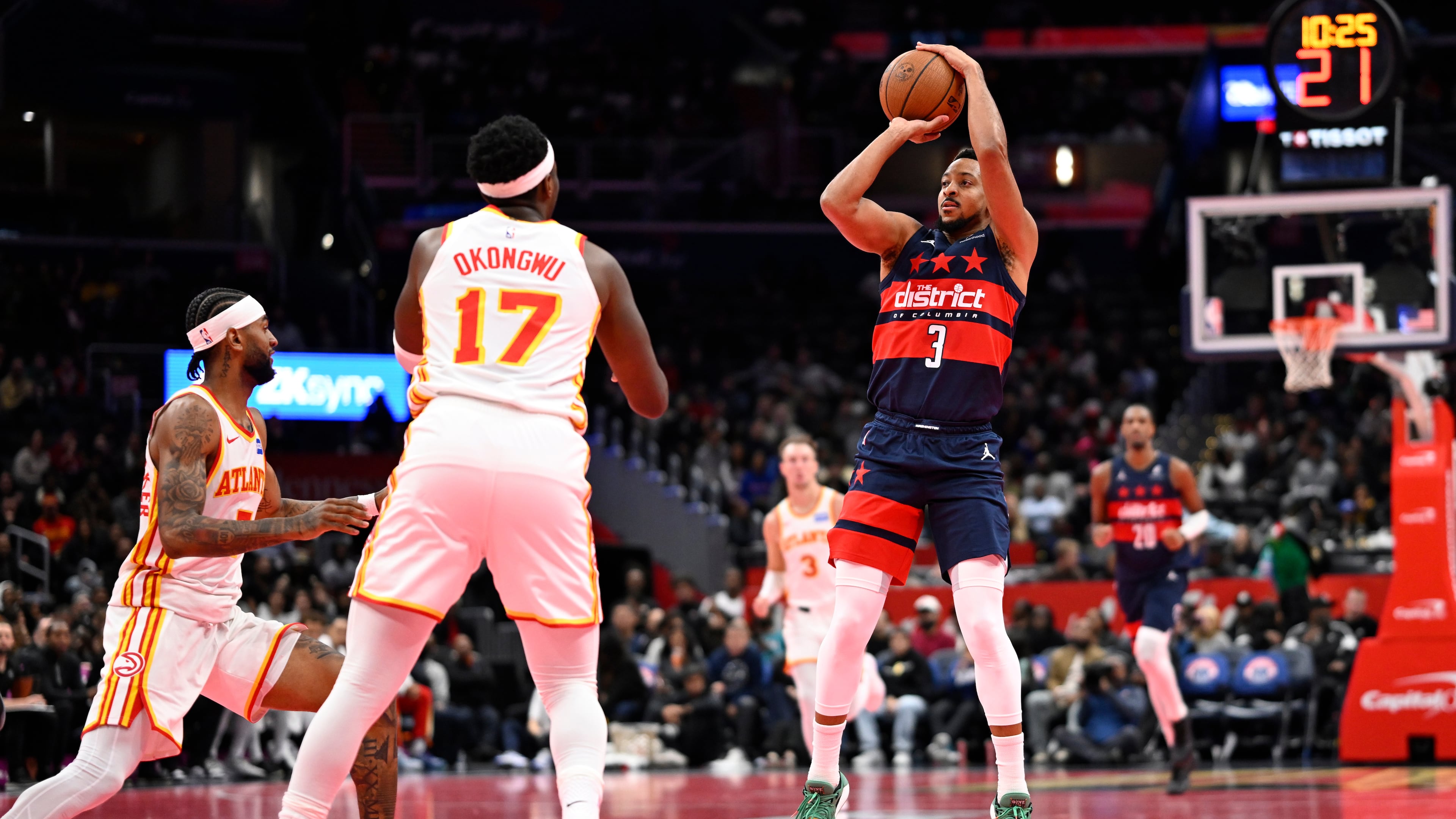 Washington Wizards guard CJ McCollum (3) launches a three point shot in front of Atlanta Hawks forward Onyeka Okongwu (17) during the first half of a Emirates NBA Cup basketball game Tuesday, Nov. 25, 2025, in Washington. (AP Photo/John McDonnell)