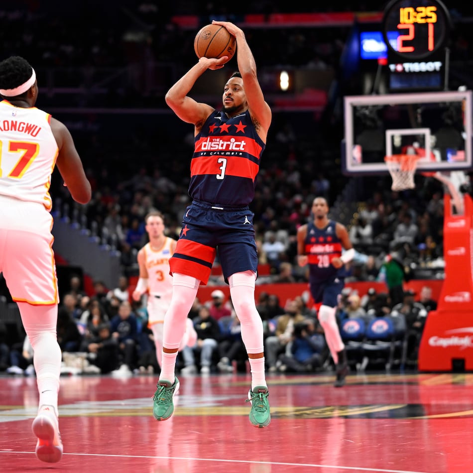 Washington Wizards guard CJ McCollum (3) launches a three point shot in front of Atlanta Hawks forward Onyeka Okongwu (17) during the first half of a Emirates NBA Cup basketball game Tuesday, Nov. 25, 2025, in Washington. (John McDonnell/AP)