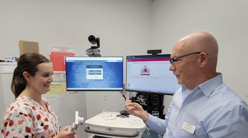 Ed Honeycutt trains Brittany Lord in telehealth services.