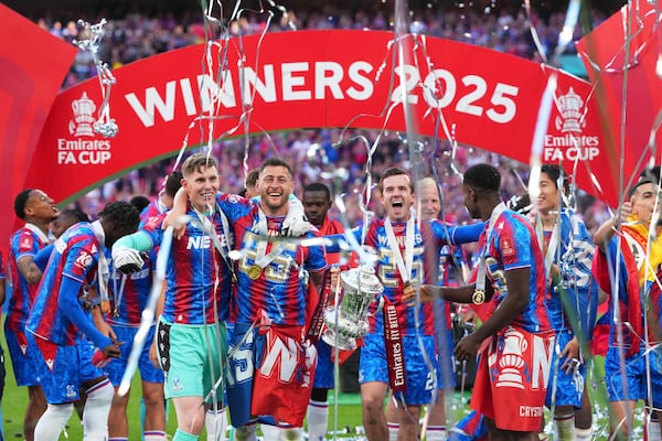 Crystal Palace players celebrate with the trophy after winning the English FA Cup final soccer match between Crystal Palace and Manchester City at Wembley stadium in London, Saturday, May 17, 2025. (AP Photo/Kirsty Wigglesworth)