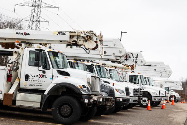Lineman bucket trucks parked outside the Holliday Inn following a severe storm that passed through in Kalamazoo Twp., Mich., Monday, March 31, 2025. (Joel Bissell/Kalamazoo Gazette via AP)