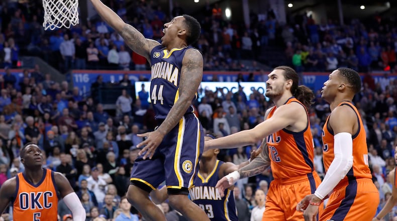 Indiana Pacers guard Jeff Teague (44) goes to the basket as Oklahoma City Thunder center Steven Adams (12) and guard Russell Westbrook (0) look on during the first half of an NBA basketball game in Oklahoma City, Sunday, Nov. 20, 2016. (AP Photo/Alonzo Adams)