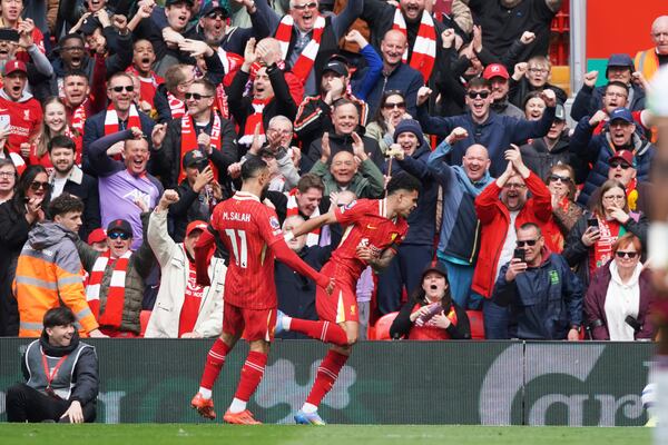 Liverpool's Luis Diaz, centre, celebrates after scoring his side's opening goal during the English Premier League soccer match between Liverpool and West Ham United at Anfield in Liverpool, Sunday, April 13, 2025. (AP Photo/Ian Hodgson)