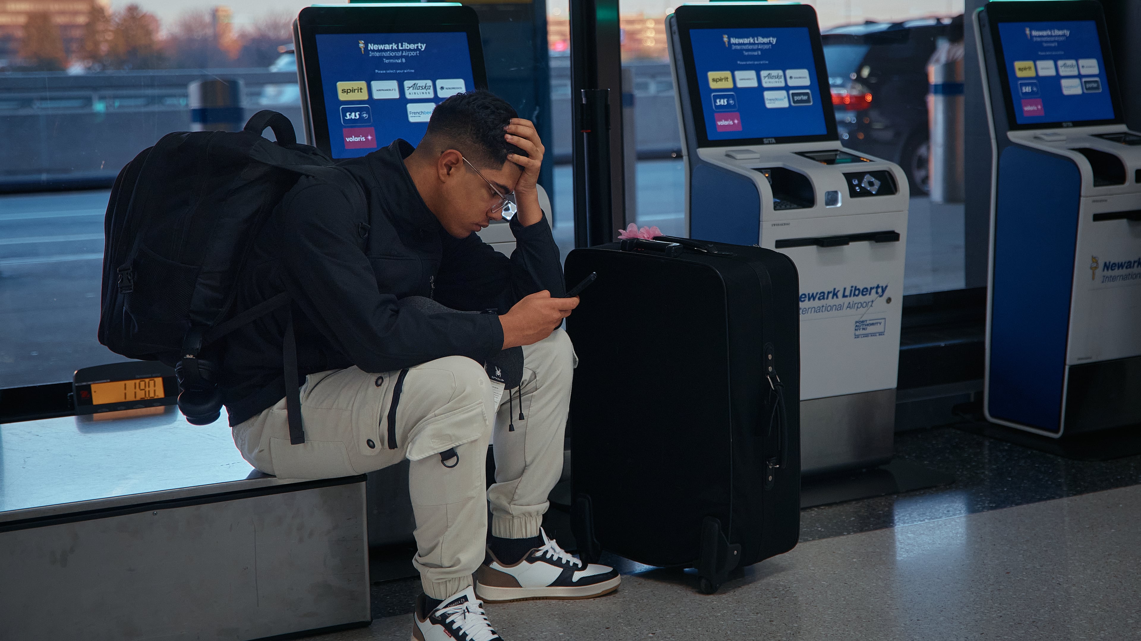 A passenger flying with Arajet to Santo Domingo waits to check in at Newark Liberty International Airport on Friday, Nov. 7, 2025 in Newark, N.J. (AP Photo/Andres Kudacki)