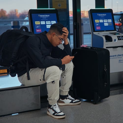 A passenger flying with Arajet to Santo Domingo waits to check in at Newark Liberty International Airport on Friday, Nov. 7, 2025 in Newark, N.J. (AP Photo/Andres Kudacki)