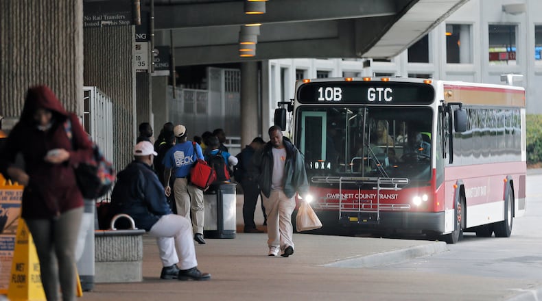In this April 2017 file photo, passengers board a Gwinnett County Transit bus at the Doraville MARTA station. BOB ANDRES /BANDRES@AJC.COM
