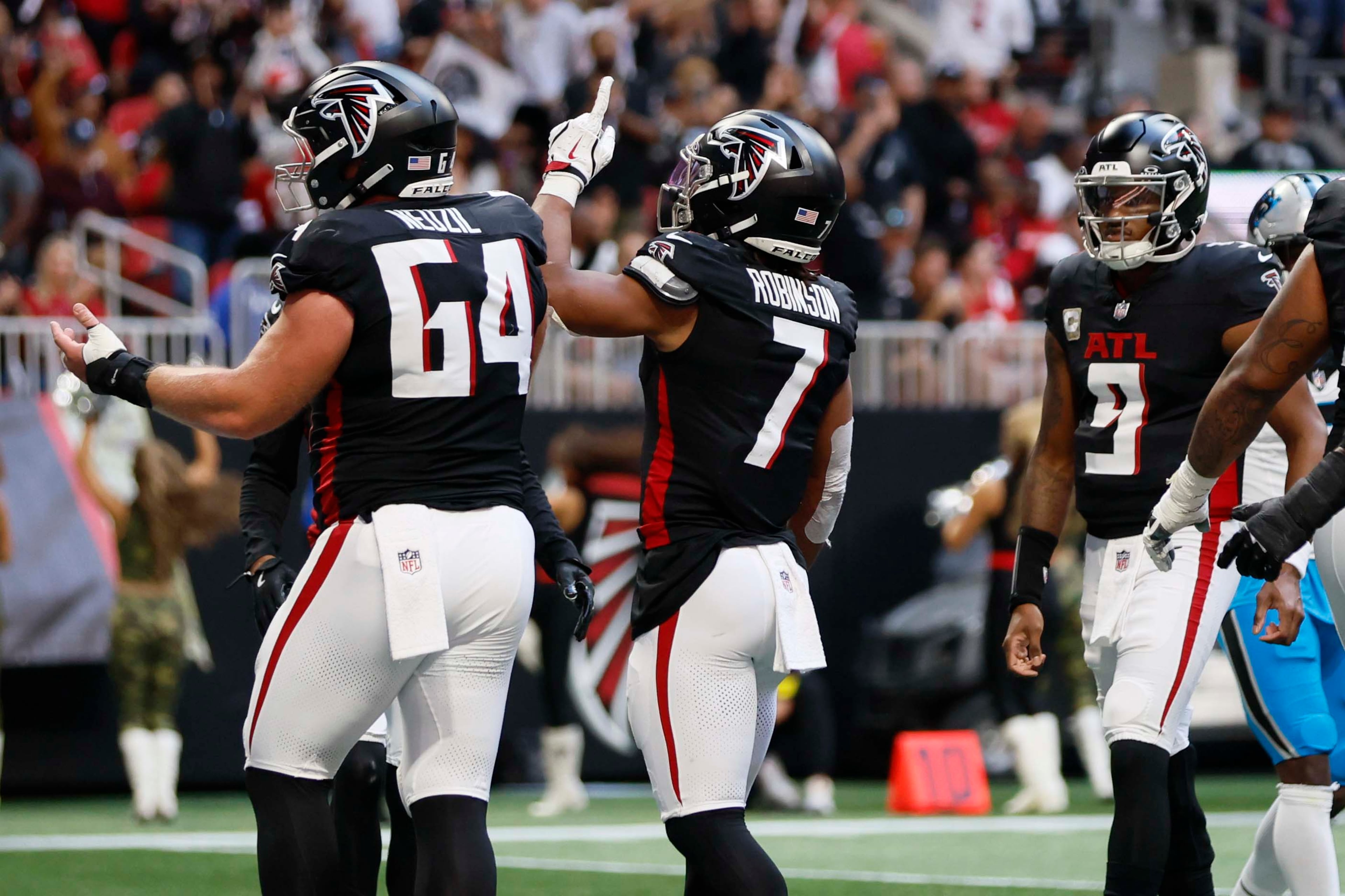 Atlanta Falcons running back Bijan Robinson (second from left) reacts after his second touchdown during the first half of an NFL game against the Carolina Panthers at Mercedes-Benz Stadium in Atlanta on Sunday, Nov. 16, 2025. (Miguel Martinez/AJC)