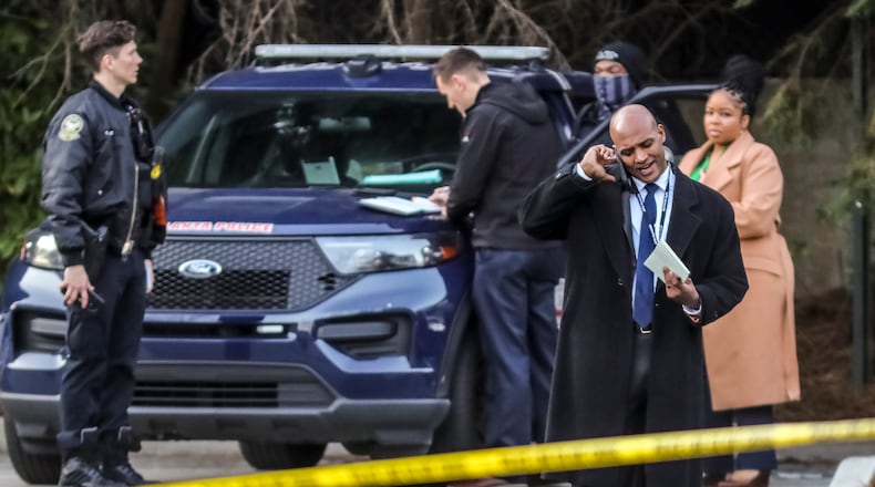 February 15, 2022 Atlanta: Atlanta police Lt. Ralph Woolfolk.(Homicide Commander) (right on phone) works the scene as the Fulton D.A.Õs officer members (right-background) and an APD uniform officer (left) wait. A man died after being shot outside a downtown Atlanta apartment building Tuesday morning, Feb. 15, 2022. The victim was found about 4:40 a.m. in the area of Hunnicutt Street and Centennial Olympic Park Drive, according to Atlanta police Lt. Ralph Woolfolk. He was taken to Grady Memorial Hospital, where he was pronounced dead. Investigators are still working to determine what led to the deadly shooting, Woolfolk told The Atlanta Journal-Constitution from the scene. ÒWe are still in the early stages of the investigation,Ó the homicide unit commander said. ÒWeÕve done a substantial amount of work here on scene, but we still have a lot of work to do here.Ó While the victim has not been identified, police believe he was about 50 years old. It was not clear if he was a resident of the Centennial Place Apartments community, which sprawls several city blocks near the Georgia Tech campus. Investigators believe the victim argued with someone before the shooting, Woolfolk said. They recovered ballistic evidence from the scene, as well as other undisclosed items Woolfolk said could become evidence. Police have not identified a suspect, and anyone with information is asked to come forward. Tipsters can remain anonymous, and be eligible for rewards of up to $2,000, by contacting Crime Stoppers Atlanta at 404-577-8477, texting information to 274637 or visiting the Crime Stoppers website. (John Spink / John.Spink@ajc.com)