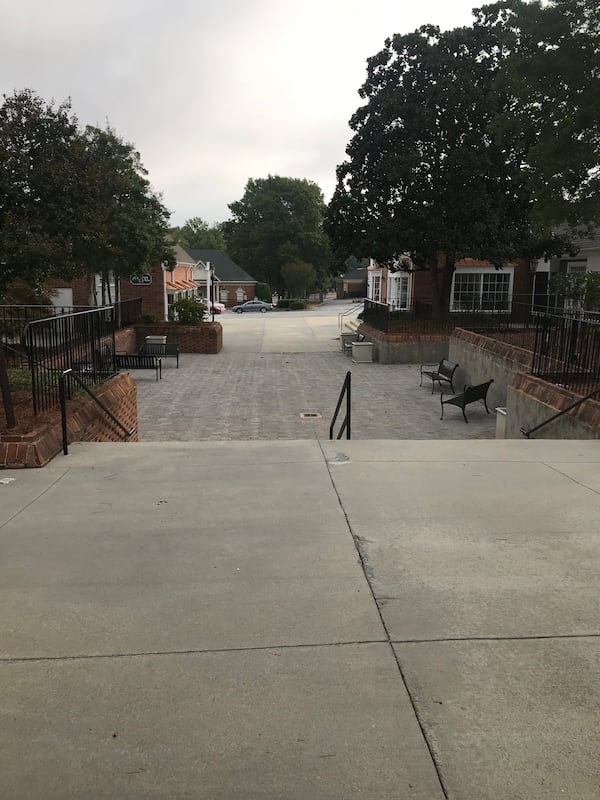 An empty courtyard at an older, brick commercial development.