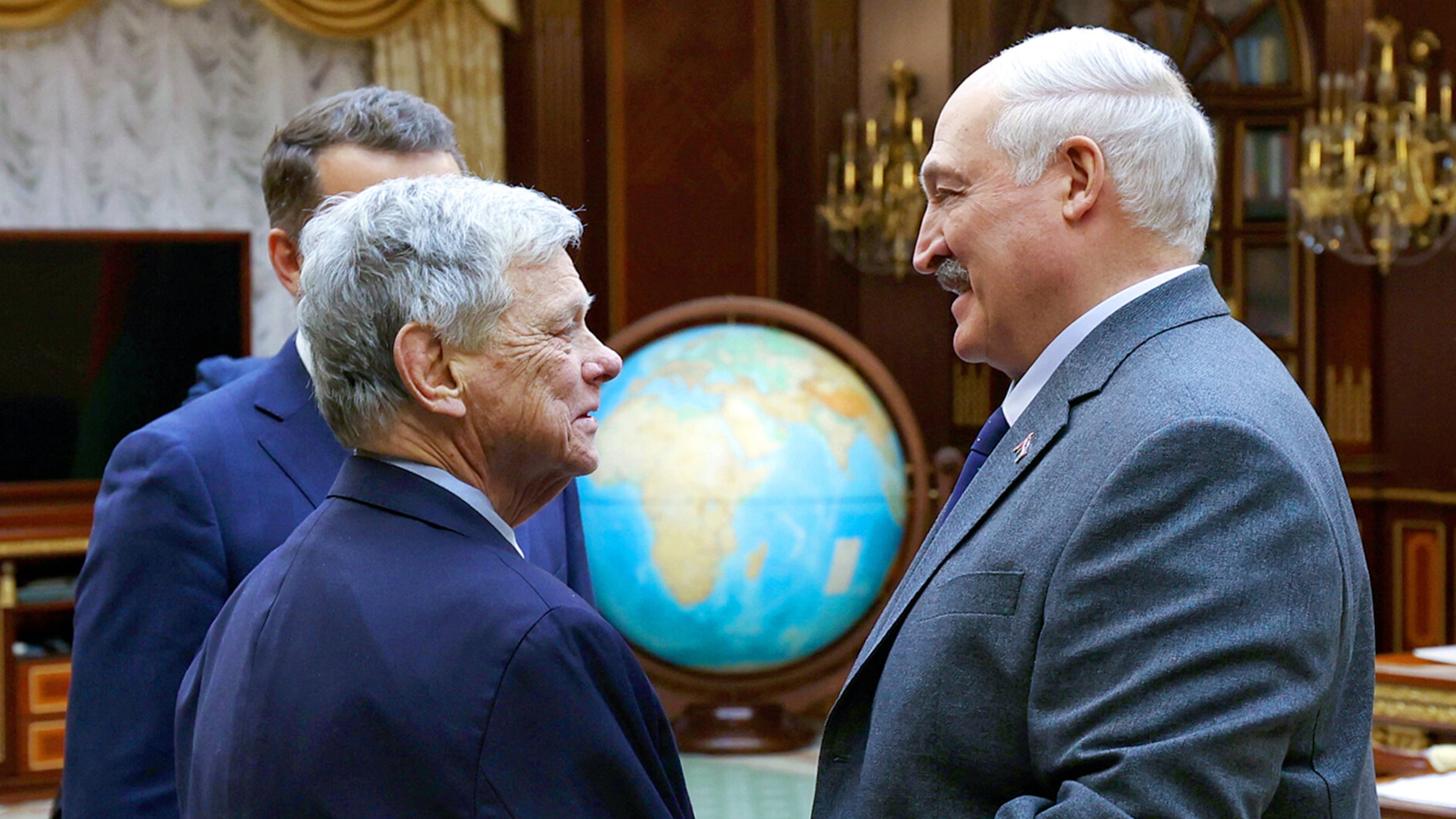 In this photo released by Belarusian presidential press service, Belarusian President Alexander Lukashenko, right, and U.S. Presidential envoy John Coale shake hands during their meeting in Minsk, Belarus, Friday, Dec. 12, 2025. (Belarusian Presidential Press Service via AP)