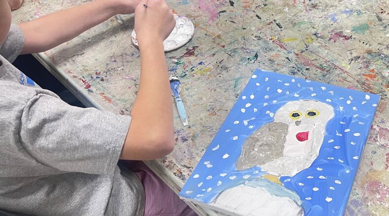 A youngster puts the finishing touches on her snowy owl drawing at the Spruill Center for the Arts. 
Photo: Courtesy of Spruill Center of the Arts