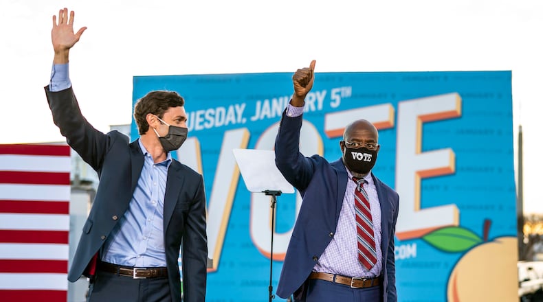 From left, Democratic Senate candidates Jon Ossoff and the Rev. Raphael Warnock wave after a campaign event with President-elect Joe Biden in Atlanta on Monday, Jan. 4, 2021. Their wins in runoff elections Tuesday gave Democrats control of the Senate. (Doug Mills/The New York Times)