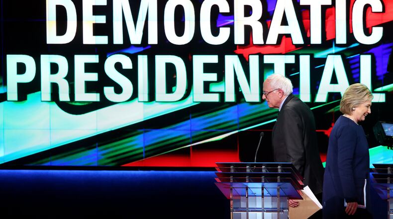 FLINT, MI - MARCH 06: Democratic presidential candidate Senator Bernie Sanders (D-VT) and Democratic presidential candidate Hillary Clinton walk off stage during a break in the CNN Democratic Presidential Primary Debate at the Whiting Auditorium at the Cultural Center Campus on March 6, 2016 in Flint, Michigan. Voters in Michigan will go to the polls March 8 for the state's primary. (Photo by Scott Olson/Getty Images) ***BESTPIX***