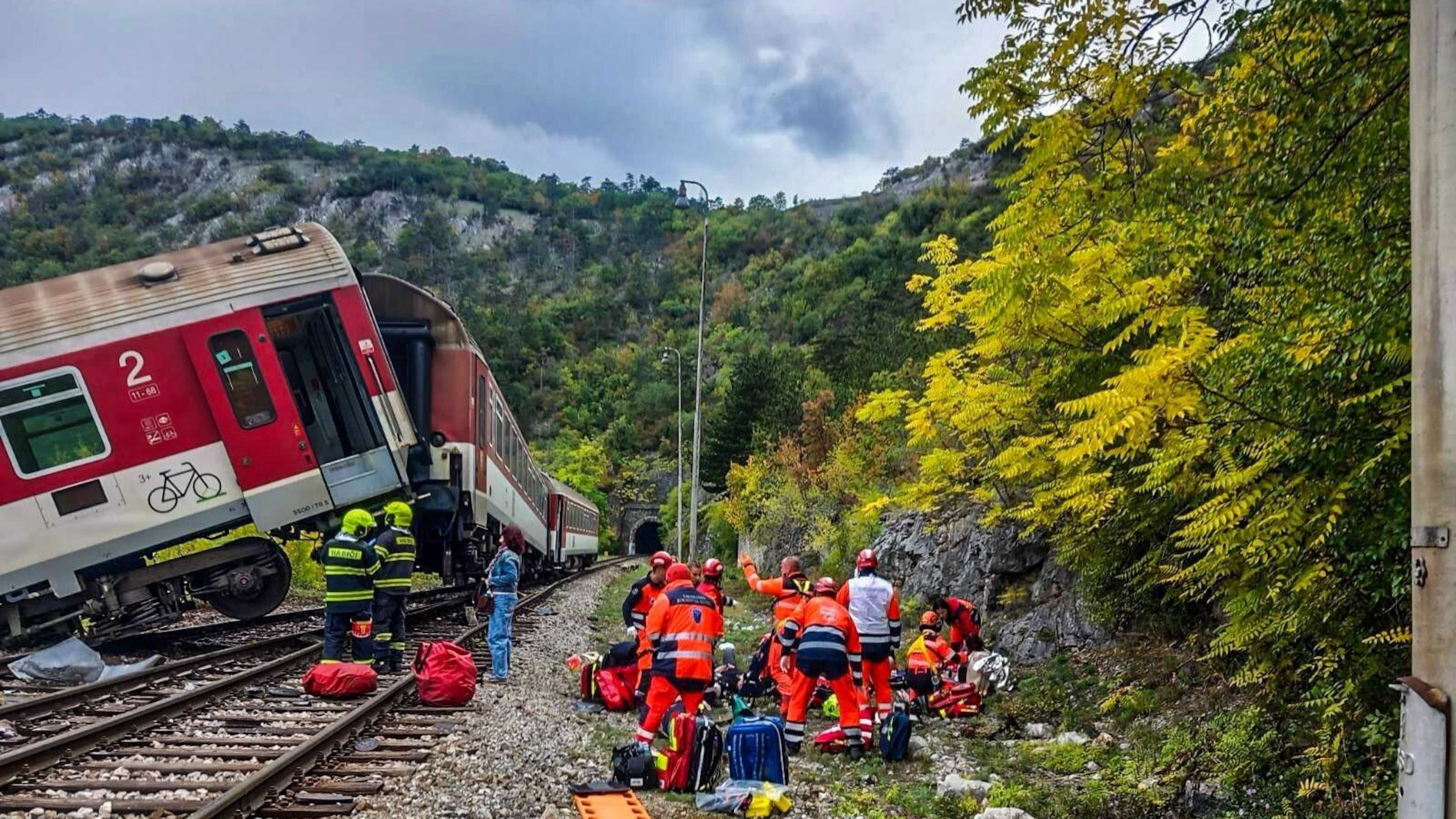In this photo released by Slovak Police, rescue workers treat wounded passengers after a train crash near Roznava, Slovakia, Monday, Oct. 13, 2025. (Slovak Police via AP)