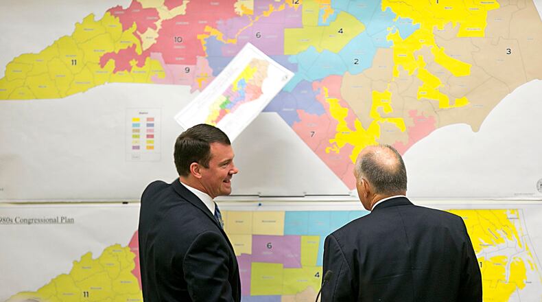 In this 2016 file photo, Republican state Sens. Dan Soucek, left, and Brent Jackson, right, review historical maps during a special session of the North Carolina legislature, called to redraw congressional district maps tossed out by federal court. Corey Lowenstein/The News & Observer, via AP