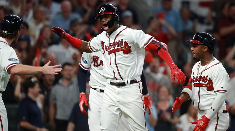 Atlanta Braves left fielder Ronald Acuna reacts after hitting a grand slam home run in the second inning against the Los Angeles Dodgers in Game 3 of a National League Division Series baseball game Sunday, October 7, 2018, in Atlanta. Curtis Compton/ccompton@ajc.com