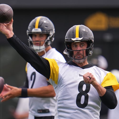 Pittsburgh Steelers quarterbacks Aaron Rodgers (8) and Mason Rudolph (2) run a drill during the NFL team's training camp in Latrobe, Pa., Saturday, Aug. 1, 2026. (AP Photo/Gene J. Puskar)