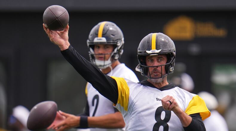Pittsburgh Steelers quarterbacks Aaron Rodgers (8) and Mason Rudolph (2) run a drill during the NFL team's training camp in Latrobe, Pa., Saturday, Aug. 1, 2026. (AP Photo/Gene J. Puskar)