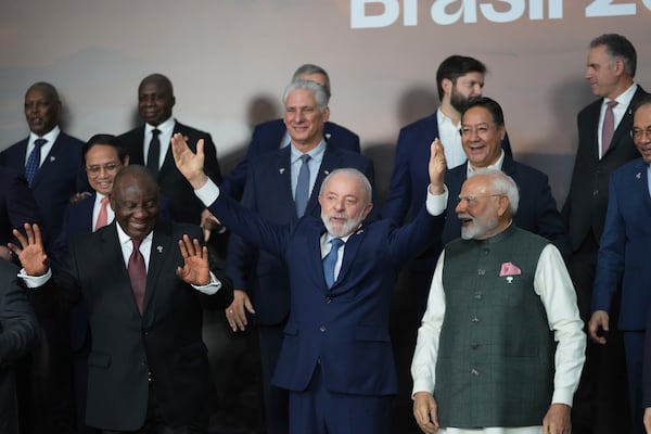 Brazilian President Luiz Inacio Lula da Silva, center, South Africa's President Cyril Ramaphosa, left, and India's Prime Minister Narendra Modi take part in a group photo during the 17th annual BRICS summit in Rio de Janeiro, Monday, July 7, 2025. (AP Photo/Eraldo Peres)