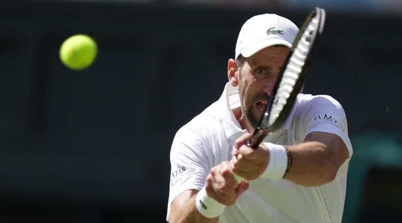 FILE - Novak Djokovic, of Serbia, returns the ball to Roman Saffiullin, of Russia, in their fourth round men's singles match at the Wimbledon Tennis Championships in London, July 5, 2026. (AP Photo/Brian Inganga, File)