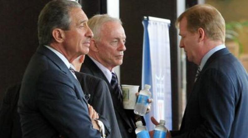 Atlanta Falcons owner Arthur Blank, from left, Dallas Cowboys owner Jerry Jones, and NFL Commissioner Roger Goodell have a conversation in the hallway outside the NFL Owners meetings at the Atlanta Airport Gateway Marriott in Atlanta on Thursday, July 21, 2011.