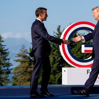 Emmanuel Macron, President of France, left, greets U.S. President Donald Trump during the G7 summit in Evian-les-Bains, France, Monday, June 15, 2026. (Christopher Katsarov/The Canadian Press via AP)