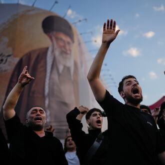 Mourners chant slogans while gathered in Islamic Revolution Square for the funeral procession of the slain Iranian Supreme Leader Ayatollah Ali Khamenei beneath a billboard depicting Khamenei in Tehran, Iran, Monday, July 6, 2026. (AP Photo/Altaf Qadri)
