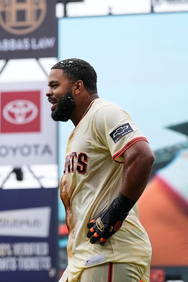 San Francisco Giants' Heliot Ramos reacts after scoring the game-wining run against the Texas Rangers during the ninth inning of a baseball game Sunday, April 27, 2025, in San Francisco. (AP Photo/Godofredo A. Vásquez)