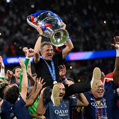 PSG's head coach Luis Enrique, top, celebrates with players after winning the Champions League final soccer match against Arsenal in Budapest, Hungary, Saturday, May 30, 2026. (AP Photo/Denes Erdos)