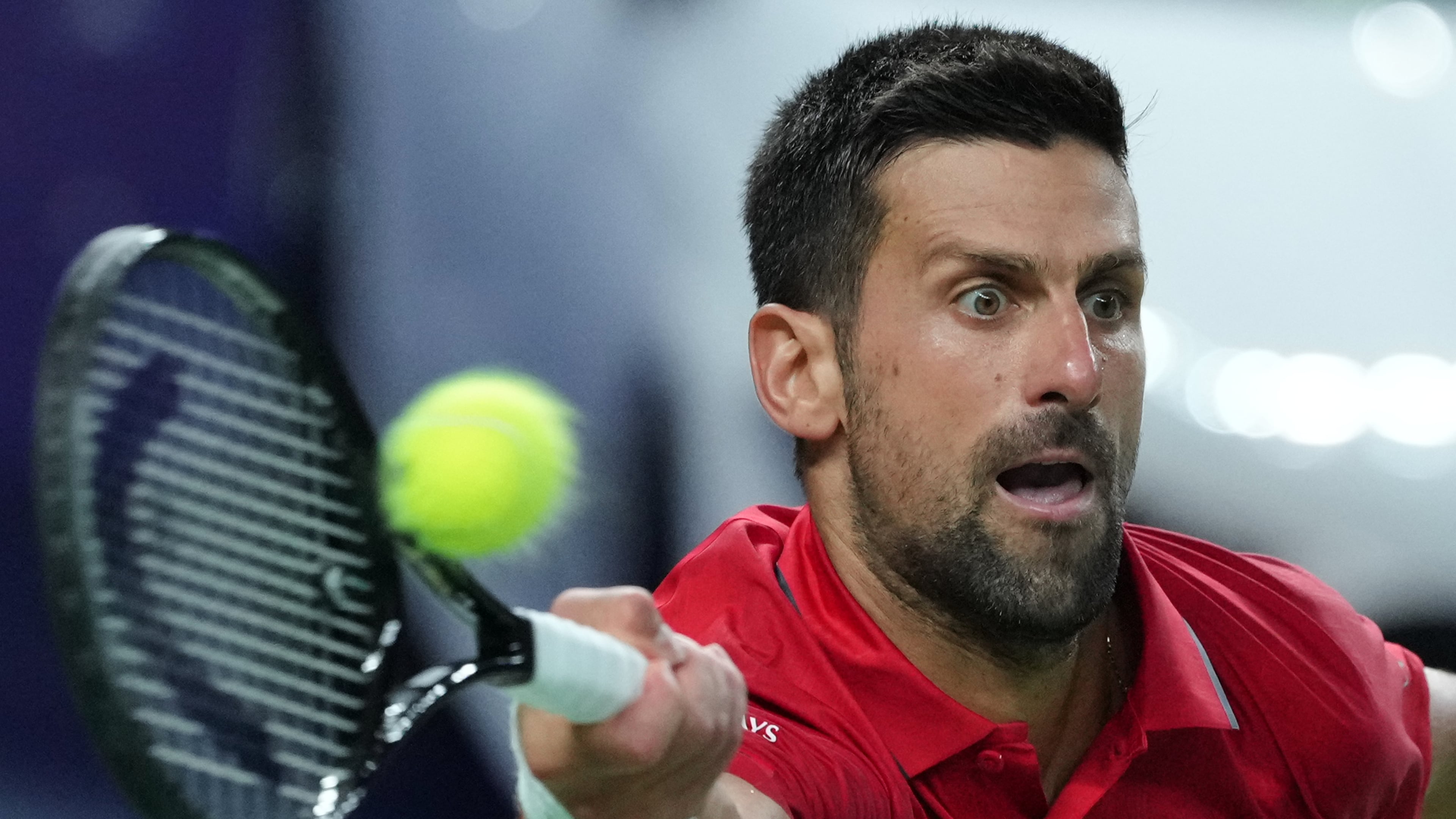 Novak Djokovic of Serbia returns a backhand shot from Zizou Bergs of Belgium during the men's singles quarterfinal match of the Shanghai Masters tennis tournament at Qizhong Forest Sports City Tennis Center, in Shanghai, China, Thursday, Oct. 9, 2025. (AP Photo/Andy Wong)