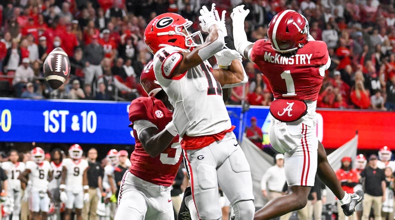 Alabama Crimson Tide defensive backs Kool-Aid McKinstry (1) and Terrion Arnold (3) block an attempted pass to Georgia Bulldogs wide receiver Arian Smith (11) during the first half of the SEC Championship football game at the Mercedes-Benz Stadium in Atlanta, on Saturday, December 2, 2023. (Hyosub Shin / Hyosub.Shin@ajc.com)