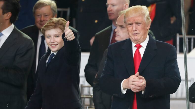 President Donald Trump, right, and his son Barron react as they view the 58th Presidential Inauguration parade for President Donald Trump in Washington. Friday, Jan. 20, 2017 (AP Photo/Pablo Martinez Monsivais)