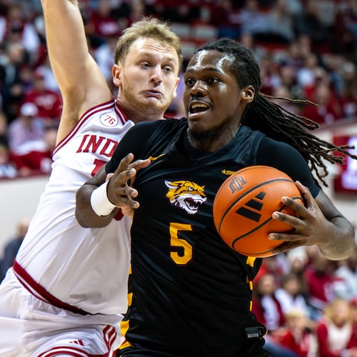 Bethune-Cookman forward Quentin Heady (5) is defended by Indiana forward Tucker Devries (12) during the first half of an NCAA college basketball game, Saturday, Nov. 29, 2025, in Bloomington, Ind. (AP Photo/Doug McSchooler)