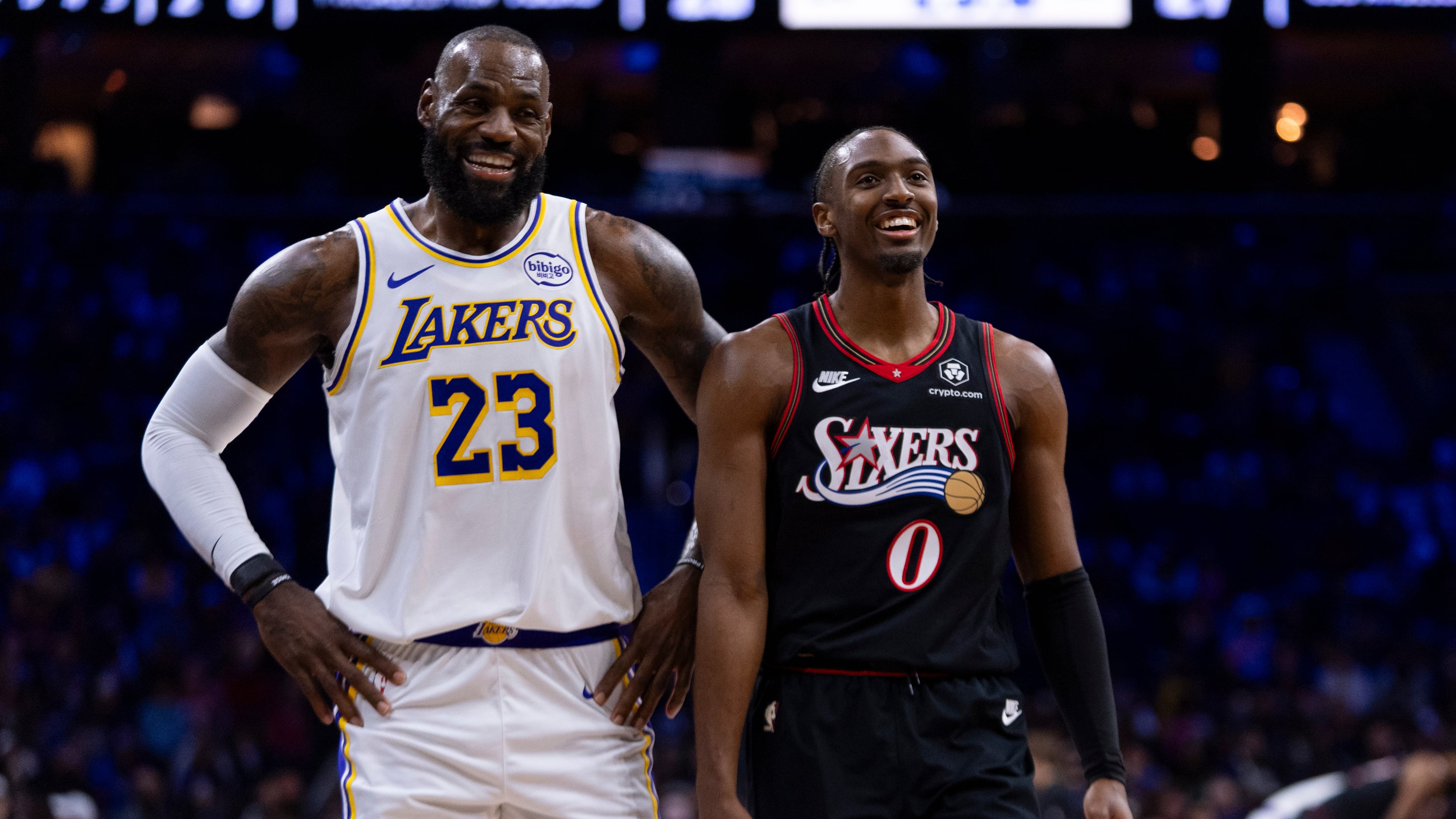 Los Angeles Lakers' LeBron James, left, talks with Philadelphia 76ers' Tyrese Maxey, right, during the first half of an NBA basketball game, Sunday, Dec. 7, 2025, in Philadelphia. (AP Photo/Chris Szagola)