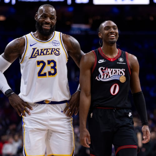 Los Angeles Lakers' LeBron James, left, talks with Philadelphia 76ers' Tyrese Maxey, right, during the first half of an NBA basketball game, Sunday, Dec. 7, 2025, in Philadelphia. (AP Photo/Chris Szagola)
