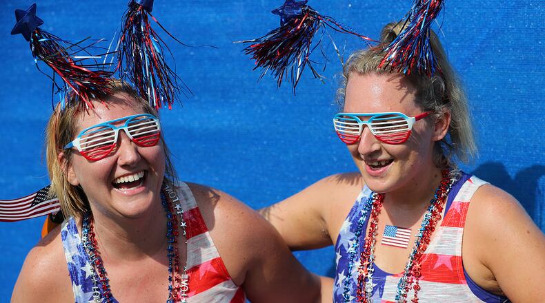 Bethany Bearden (left) and Kimberly Robinson, Gainesville, celebrate after finishing the 48th running of the AJC Peachtree Road Race on Tuesday, July 4, 2017, in Atlanta.    Curtis Compton/ccompton@ajc.com