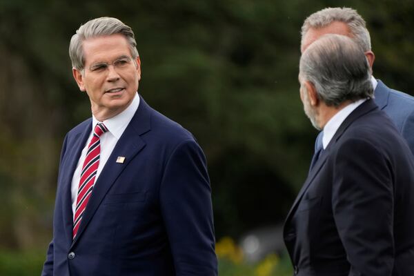 From left, Treasury Secretary Scott Bessent, Health and Human Services Secretary Robert F. Kennedy Jr. and Commerce Secretary Howard Lutnick follow President Donald Trump to board Marine One on the South Lawn of the White House en route to Florida, Friday, March 28, 2025, in Washington. (AP Photo/Mark Schiefelbein)