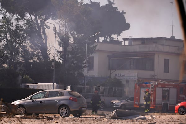 Firefighters work as smoke rises after a gas station exploded on the outskirts of Rome, Friday, July 4, 2025. (Cecilia Fabiano/LaPresse via AP)