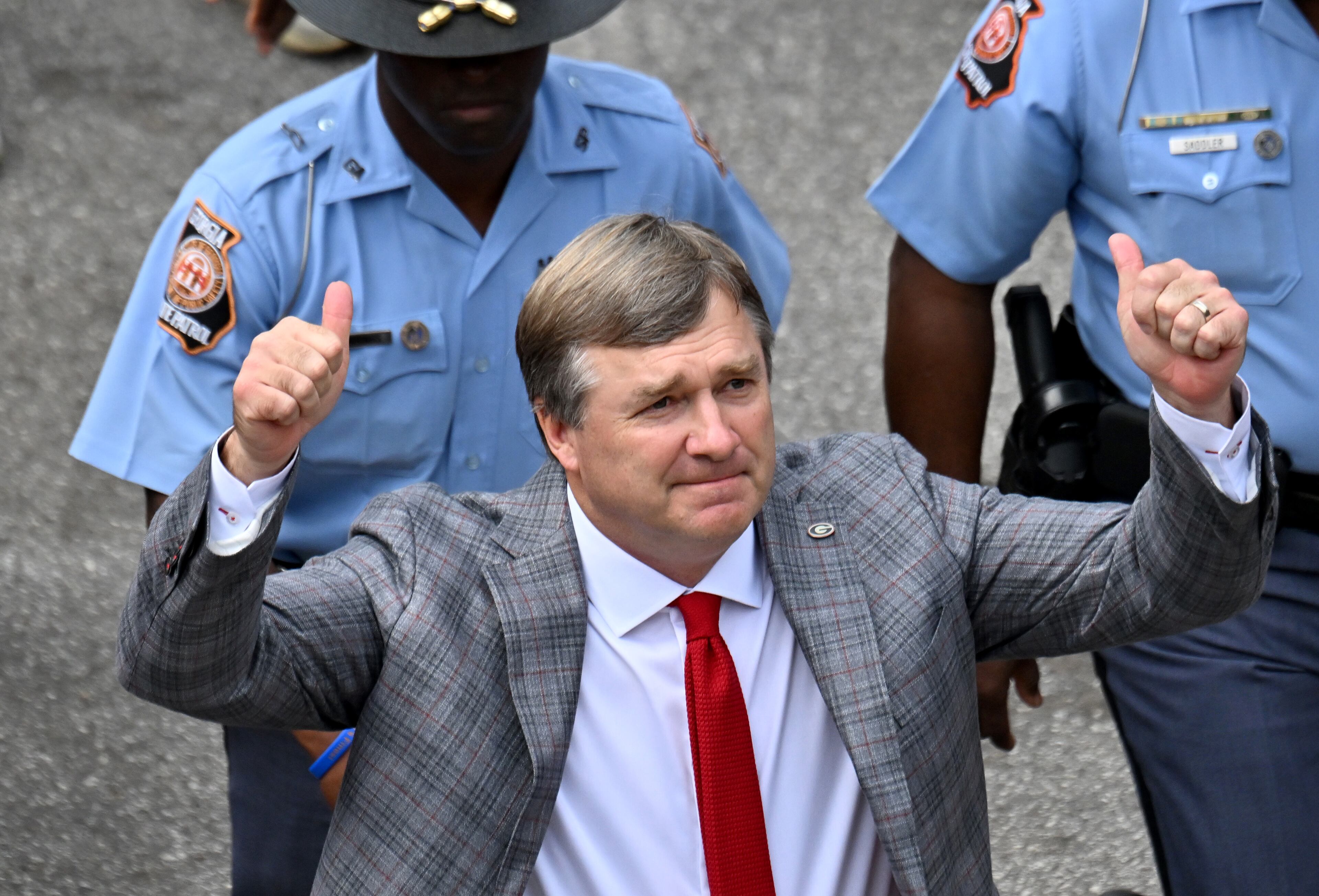 Georgia head coach Kirby Smart waves as players and coaching staff arrive during the Dawg Walk before an NCAA football game against Mississippi at Sanford Stadium, Saturday, October 18, 2025, in Athens. (Hyosub Shin/AJC)