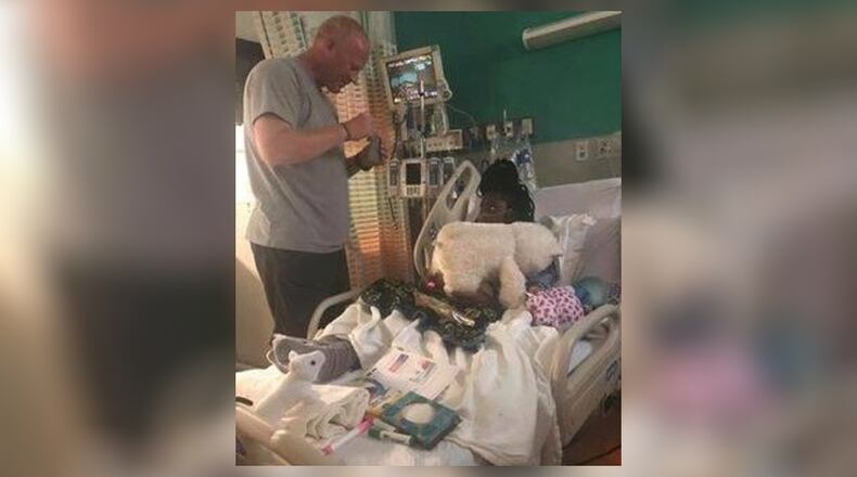 Deputy Christopher Collis (left) is being credited with helping save the life of London Anthony (right).