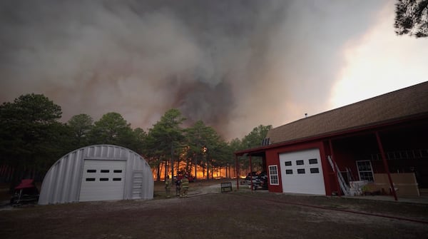 Smoke fills the sky as firefighters battle a wildfire in Lacey Townships, N.J. on Tuesday, April 22, 2025. (New Jersey Department of Environmental Protection via AP)